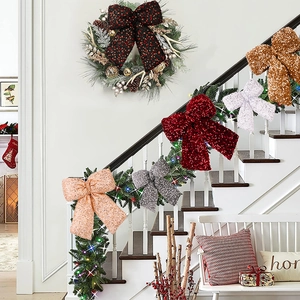 Glittery Christmas bows in assorted colors displayed on a festive staircase garland
