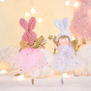 Close-up of plush rabbit ear angel ornaments with tulle star skirts and golden wings
