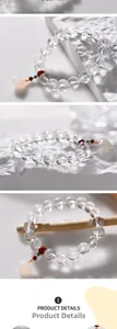 Detail of 10mm white crystal beaded bracelet with flower pendant and colorful accents