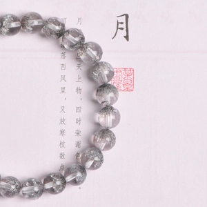 Natural 8mm silver rutilated quartz beaded bracelet on a traditional calligraphy background