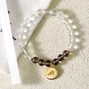 Polished crystal bead bracelet with a golden Sagittarius zodiac charm on a soft background