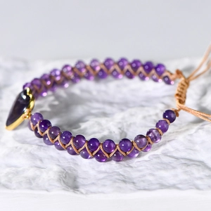 Handmade woven amethyst bead bracelet featuring a heart-shaped purple stone and adjustable cord