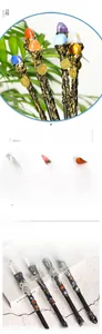 Detailed view of crystal wands with antique metal animal carvings and zodiac charms