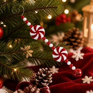 Detalle de adorno navideño de bastón de caramelo rojo y blanco con campana sobre una báscula