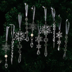Detailed view of clear acrylic snowflake and icicle ornaments on a Christmas tree