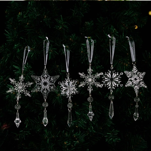 Close-up of crystal snowflake ornaments with faceted crystal drops on a Christmas tree