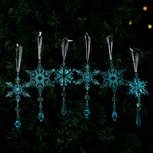 Detail of 6-piece blue snowflake ornaments with crystal teardrops on a Christmas tree