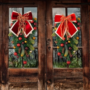 Close-up of luxury red velvet bows on teardrop swags with gold ornaments on wooden doors