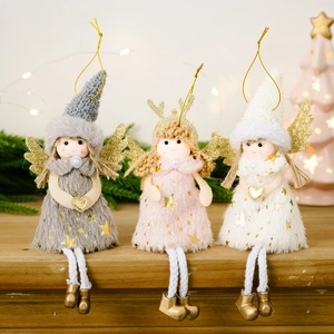 Three plush Christmas angel ornaments with pink wings and deer antlers hanging on tree