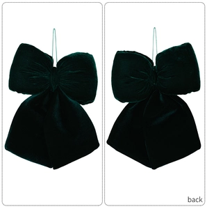 Macro shot of large dark green velvet bow with long streamers for Christmas decor