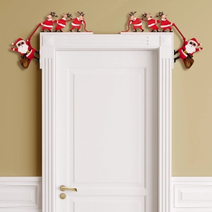 Detailed view of a wooden Santa and Reindeer corner ornament on a white door frame
