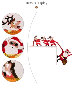 Macro detail of three-ply board Christmas door frame decor with printed Santa and reindeer
