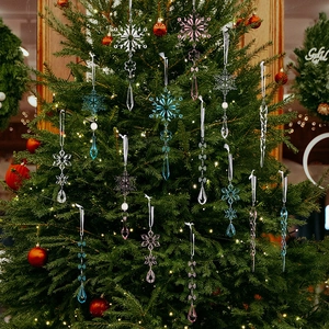 Close-up of clear and tinted acrylic icicles and snowflake ornaments on a Christmas tree