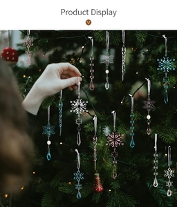 Detailed close-up of clear acrylic icicle and snowflake ornaments hanging on a Christmas tree