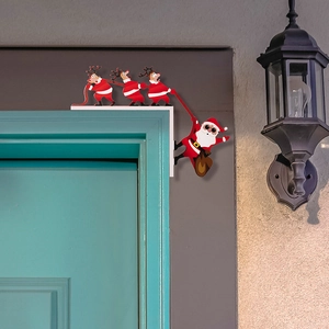 Detail of creative Santa and reindeer wooden frame ornament on a door corner