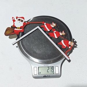 Weight measurement of Santa and reindeer Christmas door ornament showing 21.9g on scale