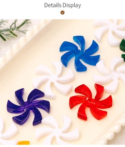 Detail display of colorful acrylic candy ornaments in fan shapes on a vintage tray
