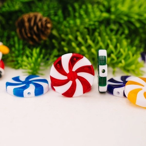 Macro detail of colorful spiral candy beads with holes for DIY Christmas decor