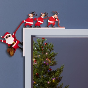 Christmas corner decoration with Santa and reindeer on a white door frame for holiday