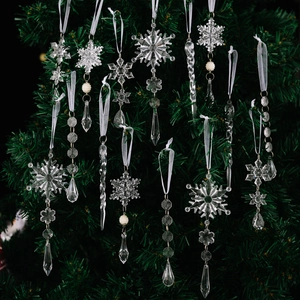 Clear acrylic Christmas ornaments set with snowflakes and icicles on a dark tree