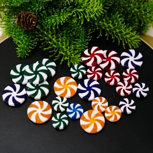 Colorful peppermint candy ornaments with red and white spiral stripes for Christmas decor