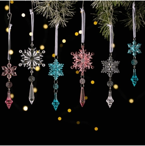 Set of crystal acrylic snowflake pendants with colorful water drop beads on a pine branch