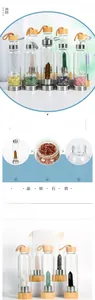 Detailed view of natural crystal hexagonal pillar inside glass water bottle with bamboo lid
