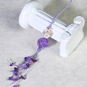 Natural raw amethyst crystal keychain with purple hand-woven mesh and floral accents