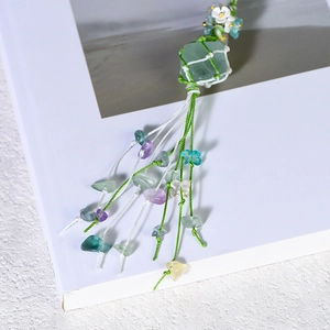Handmade woven green fluorite stone keychain with colorful tassels and floral decoration