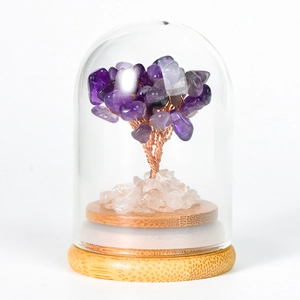 Natural amethyst crystal tree in a glass dome with a rustic wooden base for home decor