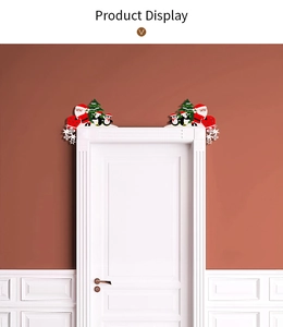 Christmas door frame decor featuring Santa Claus, penguin, and tree on a white door corner