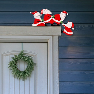 Detail of creative Santa Claus door frame decoration with cartoon characters climbing