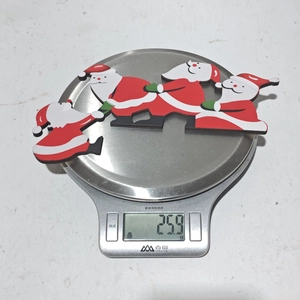 Detailed view of lightweight Christmas Santa door decor on a scale weighing 25.9g