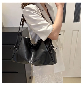 Close-up of black matte PU leather tote bag with VVGNOGZH embossed letter detail