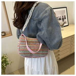 Detail of colorful woven shoulder bag with butterfly embroidery and pearl chain strap