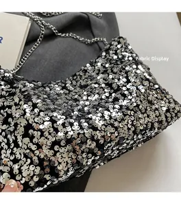 Macro detail of shimmering silver sequins and black fabric texture on the chain bag