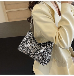 Silver sequin shoulder bag with chain strap shown on a beige blazer outfit