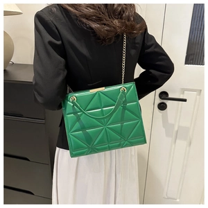 Green quilted geometric handbag with gold chain strap shown on professional model