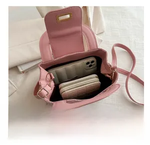 Pink quilted bag interior showing capacity for smartphone and wallet with gold lock
