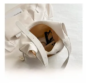 Top view of cream white bucket bag showing large interior capacity with essentials