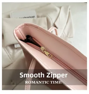 Close-up of smooth gold metal zipper and pink woven texture on retro tote bag