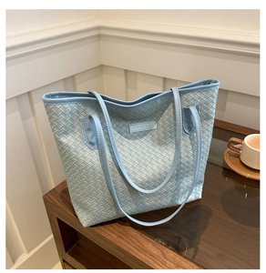 Close-up of light blue woven texture tote bag with Fashion & Bags leather label