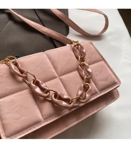 Detail of pink quilted crossbody bag showing soft matte texture and resin chain strap