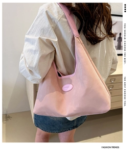Detailansicht der pinkfarbenen Nylon-Tragetasche mit breitem Gurt und großem Volumen
