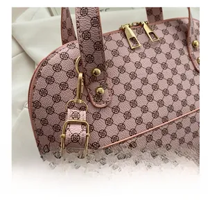 Detailed close-up of premium gold-toned metal hooks and hardware on a pink patterned bag