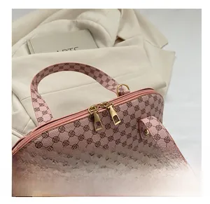 Close-up of pink shell bag featuring clover print and smooth golden double zippers