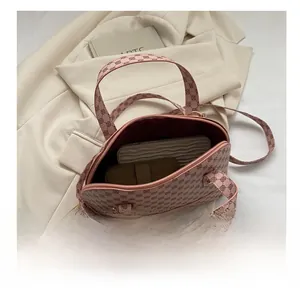 Detailed interior view of a pink shell handbag showing spacious capacity for wallets