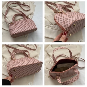 Detail view of pink printed Boston bag with gold hardware, rivets and interior space