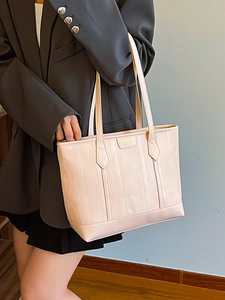 Chic beige textured tote bag with vertical bark grain pattern and gold metal logo