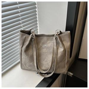 Detail showing the gray vintage texture and silver chain strap on a large tote bag